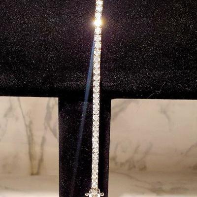 14kt white gold stamped custom made diamond ladies style tennis bracelet.
4prong settings.
Natural Diamonds.
7.5inches long. 
4.76 cts...