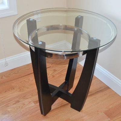 Item #7 1 of 2 Round Glass Top End Tables  
Beautiful Very trendy and stylish. 26