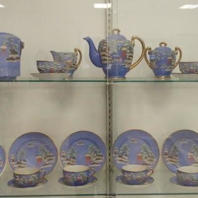 1024	23 PIECE H.P JAPAN  MORIAGE TEA SET, INCLUDES A MATCHING BISCUIT JAR AND VASE, TEA POT 7 IN H, BLUE WORN IN THE CENTER OF ONE SAUCER
