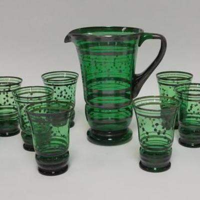 1025	11 PIECE GREEN GLASS LEMONADE SET W/ PAINTED SILVER DECORATION, PITCHER IS 9 IN H 
