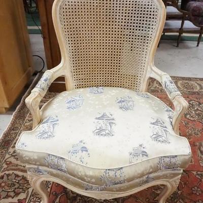 1065	CARVED FRENCH STYLE CANE BACK ARM CHAIR W/ UPHOLSTERED SEATS AND ARM RESTS, PAINTED WHITE 
