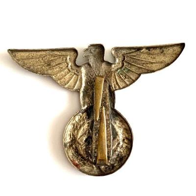 A Kriegsmarine Breast Eagle in gilded aluminum, measuring approx 37mm x 96mm with horizontal pinback and upward facing prong, excellent...