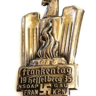 A 1935 CELEBRATORY FRANKENTAG HESSELBERG DISTRICT BADGE A 1935 badge for district day for Hesselberg. In die stamped silvered metal,...