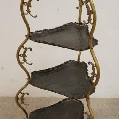 1003	BRASS AND COPPER 3 TIER STAND	BRASS FRAMED STAND WITH 3 EMBOSSED TRIANGULAR COPPER TRAYS. 37 IN H
