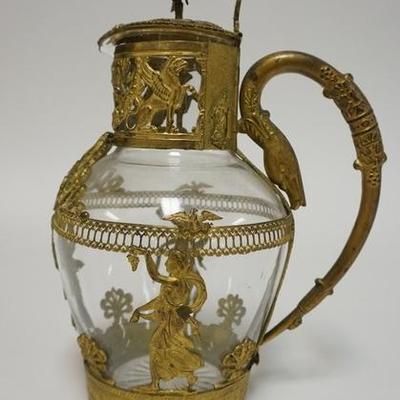 1086  ANTIQUE BLOWN CRYSTAL PITCHER WITH ORNATE BRASS MOUNT AND LID FEATURING LADIES, WINGED GRIFFENS, EAGLES ETC. SWAN HEAD HANDLEL 8...