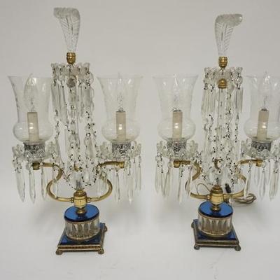 1009 PAIR OF CRYSTAL LAMPS WITH CUT HURRICANE SHADES, CUT PRISMS, BLUE GLASS DECORATION AND GLASS PLUME CRESTS. 21 1/2 IN H. ONE CORD IS...