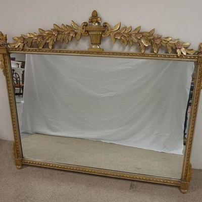 1045  LARGE MIRROR IN GILT FRAME WITH FLORAL AND URN CREST. OVERALL APP 60 IN X 48 IN
