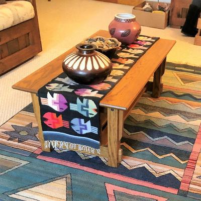 Oak coffee table with runner and southwestern decor