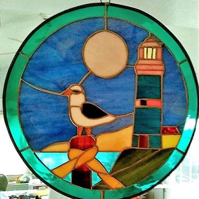 Stained glass circle with lighthouse and shorebird