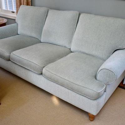 One of a pair of aqua sofas