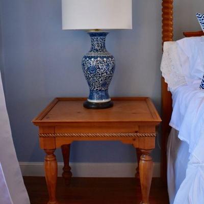 One of a pair of matching Broyhill Furniture bedside tables and blue and white pottery lamps