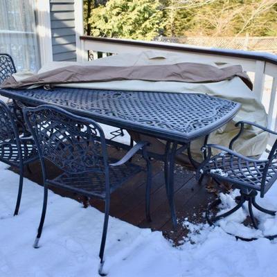 Cast metal patio table with 6 chairs