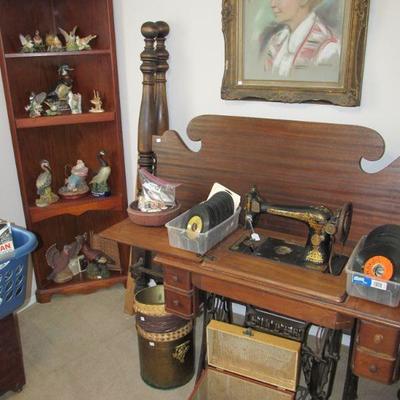 1920s Singer sewing machine w/ cabinet, antique full/queen size bed & 1 of 2 corner shelves.