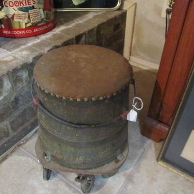 Antique milking stool on wheels w/ storage.