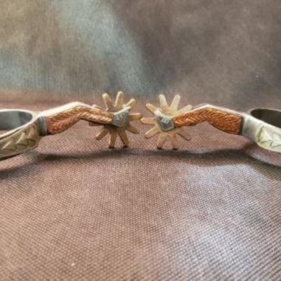 Vintage stainless steel Lady Leg Spurs with copper and silver accents, brass rowels.  https://ctbids.com/#!/description/share/326804