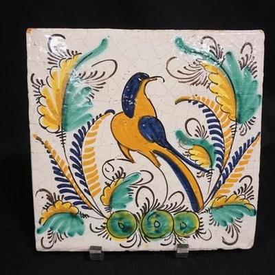 1181	LARGE HAND PAINTED TILE W/ BIRD & FOLIAGE, HAS A SMALL CHIP IN UPPER LEFT HAND CORNER, 9 7/8 IN X 9 3/4 IN 
