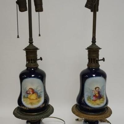 1078	PAIR OF HAND PAINTED PORCELAIN LAMPS, ON A COBALT BLUE BACKGROUND, ONE SIDE HAS CHILDREN THE REVERSE HAS A FLORAL BOUQUET  ONE...