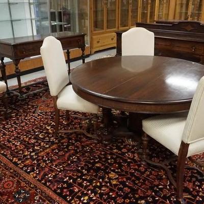 1055	EIGHT PIECE WALNUT CARVED & INLAID DINING ROOM SET, ROUND TABLE W/ UNUSUAL BASE & TWO LEAVES, UPHOLSTERY ON CHAIRS HAS STAINING 

