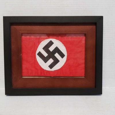 7506: Framed Nazi Swastika Armband
This lot contains a frames Nazi Swastika Armband