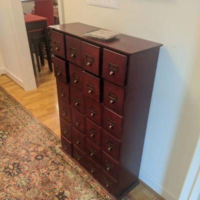 Filing system, wooden, light ware. no name. 24 drawers. dimensions (in inches) are 27.25w x 9.25d x 39.75h $125