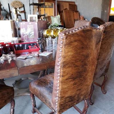 Gorgeous cowhide chairs and huge ranch style table!