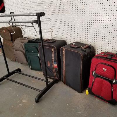 Lot # 253 - $75 SIX pieces of luggage and Adjustable clothing rack & hanging door hanger for clothing (hanging on the rack) 
