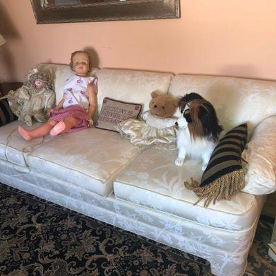 The couch in between with dog and dolls
