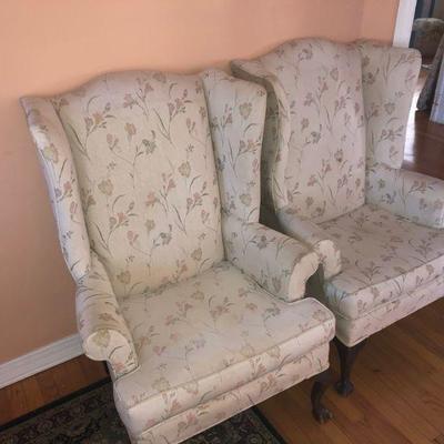 Two upholstered wingback chairs