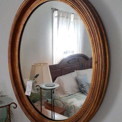 Beautiful gold toned oval mirror.  Antique