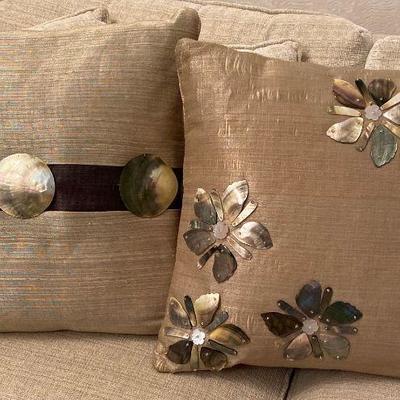 Accent pillows with mother of pearl decorations