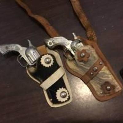2 leather holsters with guns
