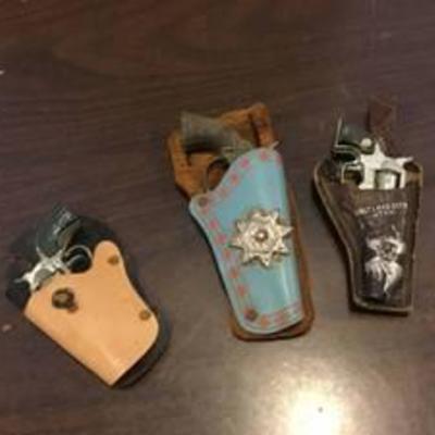 3 small holsters with guns