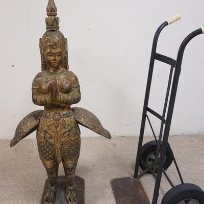 1050	LARGE CARVED WOODEN TEMPLE GOD WITH JEWELED DECORATION. 51 IN HIGH, APP 26 IN DEEP APP 26 IN WIDE
