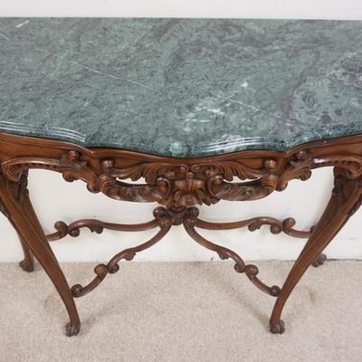 1020	CARVED MAHOGANY DEMILUNE CONSOLE WITH GREEN MARBLE TOP. HAS A CARVED STRETCHER WITH FINIAL. 
