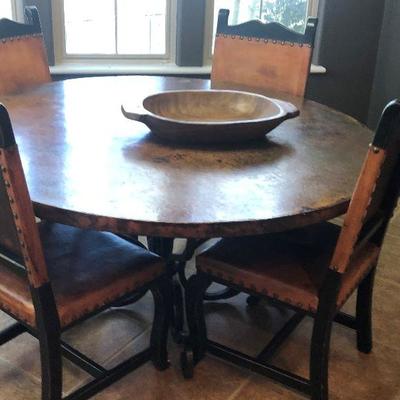 This table has a copper top and wrought iron base.  The chairs are distressed leather, one needs to be repaired (ripped).  Purchased in...
