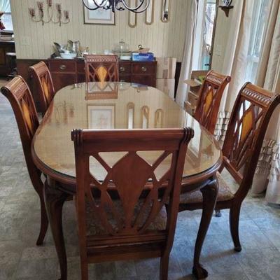 Dining Room Table and Chairs with Glass Top. Shown with two leaves so will be smaller without leaves. Beautiful set only 495.00 presale...
