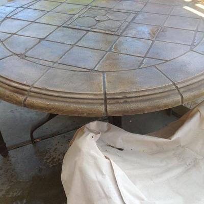 Tropitone stone table and 4 chairs all with covers. Asking $350