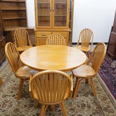 1100	EIGHT PIECE BLONDE OAK DINNING ROOM, ROUND TABLE W/ ONE WIDE LEAF, SIX BENTWOOD CHAIRS, & A CHINA CABINET W/ LEADED DOORS FRAMED IN...