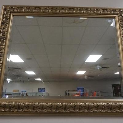 1063	BEVELED MIRROR IN SILVER GILT FRAME, OVERALL DIMENSIONS, 34 1/2 IN X 28 1/4 IN 
