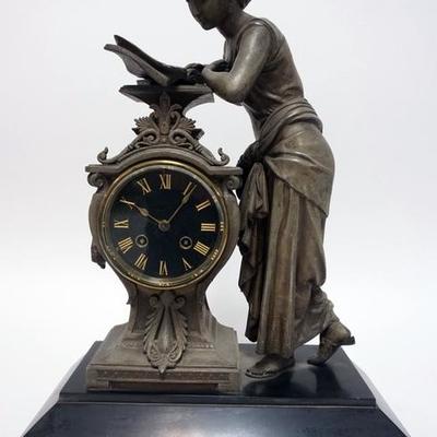 1013	VICTORIAN FIGURAL METAL AND MARBLE MANTLE CLOCK . 18 IN HIGH, 13 1/4 IN WIDE AND 6 1/4 IN DEEP.
