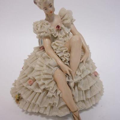 1015	LARGE PORCELAIN SEATED BALLERINA WITH OPEN LACE DRESS. THERE IS AN UNDERGLAZE EMBOSSED NUMBER OF 206, 7 1/2 IN TALL
