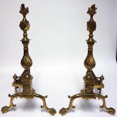 1003	PAIR OF BRASS ANDIRONS WITH BALL AND CLAW FEET, FLAME FINIALS AND SWIRL POSTS. HEAVY AND WELL MADE. 24 3/4 IN H, 23 IN LONG
