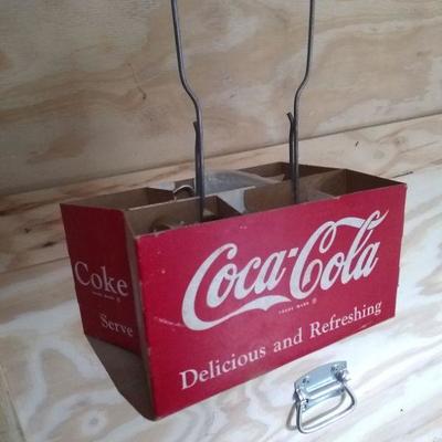 Several coke cardboard carrier s