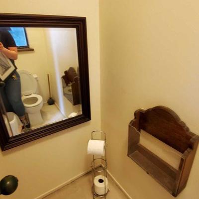 Framed mirror, toilet paper holder and magazine wall holder.