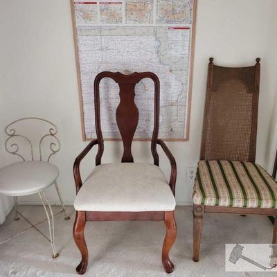 One metal chair, wooden chair with arm rests, one wicker back chair. 