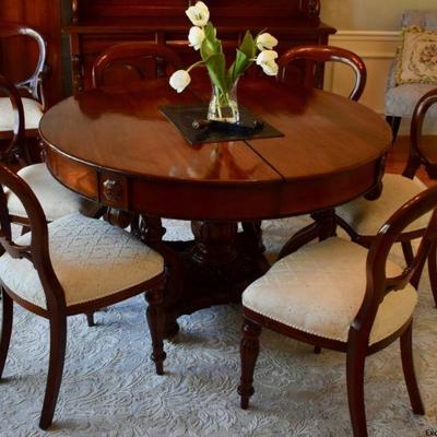 Reproduction antique English dining table with 3 leaves.  Split pedestal base extends with crank mechanism