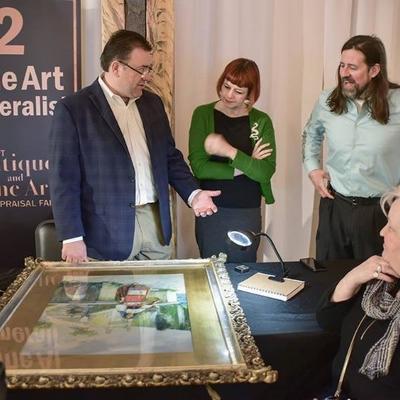 Jason Roske, Amy Abshier and Justin Rogers appraising a painting at the KCPT Antique and Appraisal Fair last spring.
