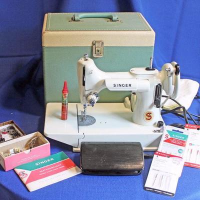 Lot 55: 1964 White Singer Featherweight machine with case and accessories- Runs $300