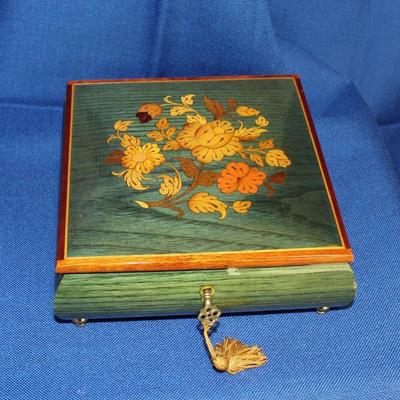 Lot 29: Reuge Green Music Box...has been overwound, plays intermittently...key is not attached to tassle  $20