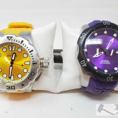 754	

Two Invicta Watches
Includes silver and yellow invicta watch, black and purple invicta watch
 